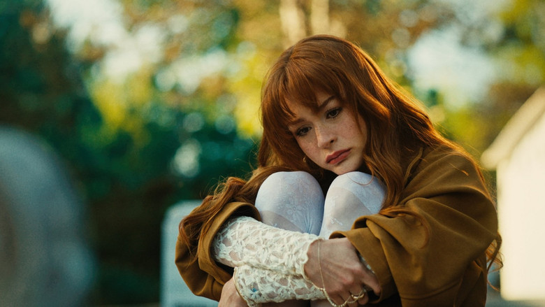 Yasemin stands in a dimly lit hallway, her silhouette framed by sickly neon greens