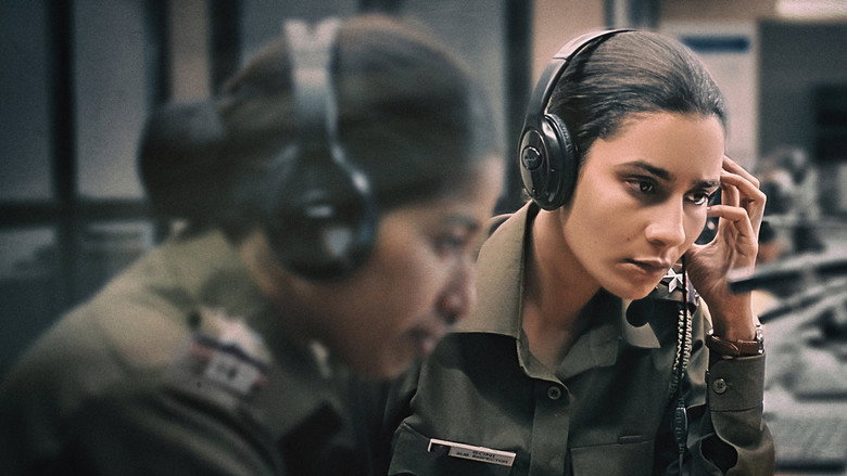 Two policewomen in uniform walking down a dimly lit Delhi street at night, their faces half in shadow.