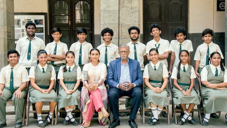 Naina Mathur standing in front of her classroom, her face mid-tic, the students watching her with a mix of curiosity and wariness