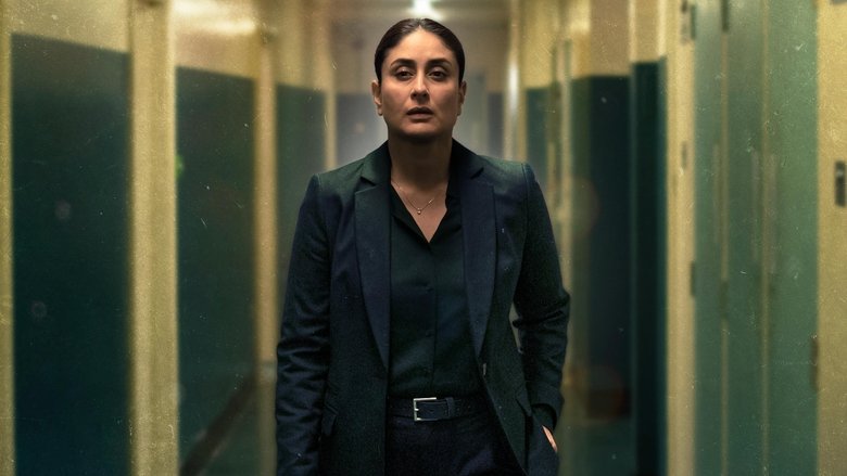 Jasmeet Bhamra stands in a dimly lit room, her face half-shadowed, the weight of grief etched into her posture.
