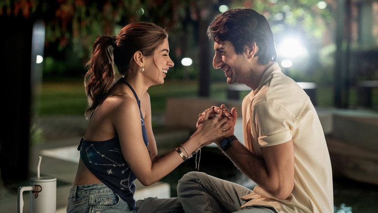 A lavish Delhi party scene, all golden lighting and designer outfits, where the leads stand awkwardly apart