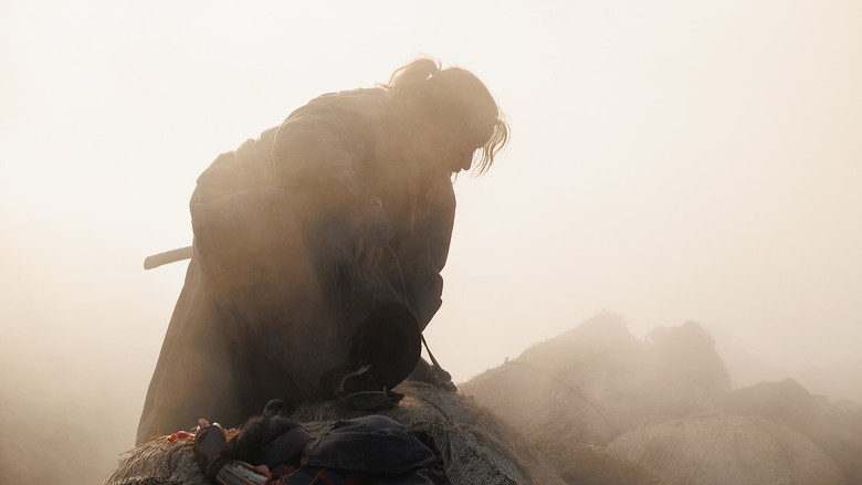 Shujiro Saga confronts an opponent in the dim light