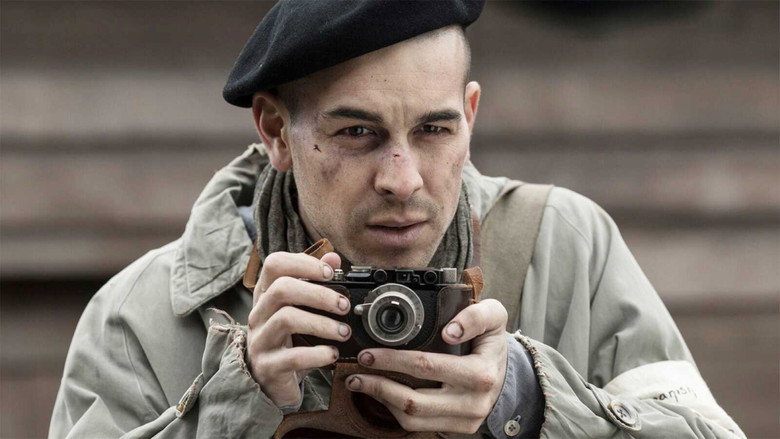 A prisoner in Mauthausen stares directly into the camera, his face gaunt, his eyes hollow but defiant.