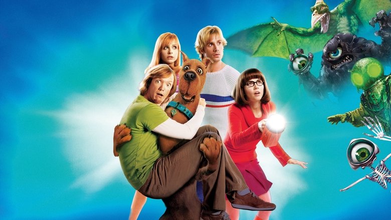 The gang stands in a dimly lit museum, surrounded by the costumes of their past defeated monsters, their faces a mix of awe and unease.