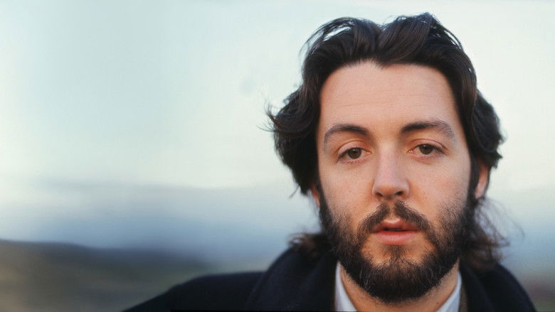 Paul McCartney performing in an intimate, low-key setting with Wings, capturing the raw, stripped-back aesthetic of the early 70s tour