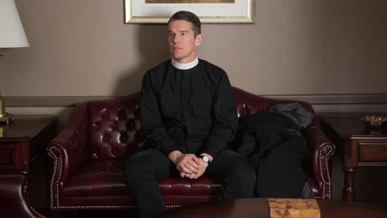 Reverend Toller writing in his ledger, the dim light of the church casting long shadows across the page.