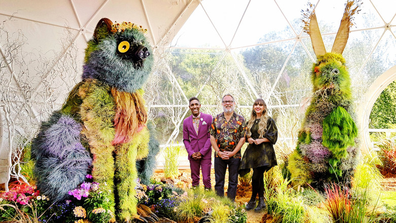 Contestants hunched over a half-built floral sculpture, their workspace littered with petals and tools
