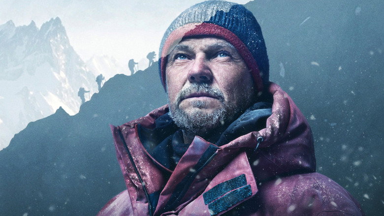 A climber's gloved hand grips a jagged ridge of ice, the vast expanse of snow and sky stretching endlessly beyond.