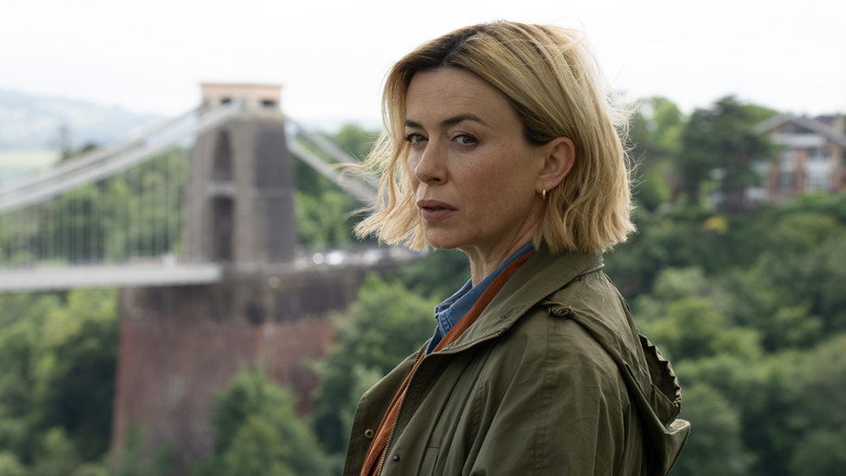 A wide shot of a modern, slightly eerie suburban house at dusk, emphasizing the isolation of the setting