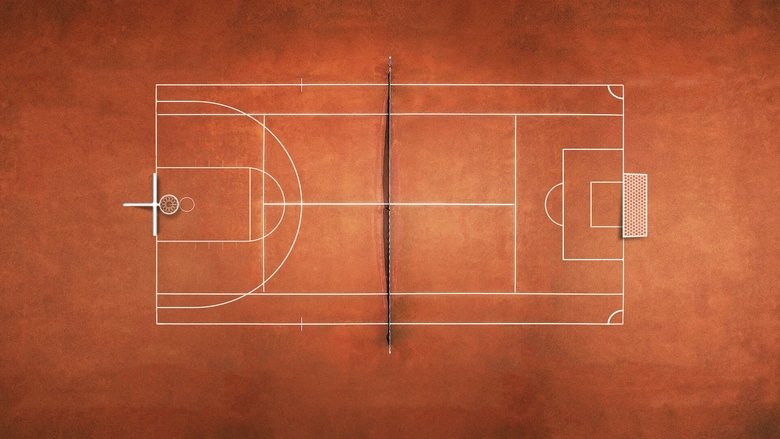 A coach stands on the sidelines, arms crossed, watching the game with intense focus.