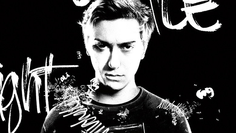 A dimly lit bedroom, the glow of a laptop screen casting eerie shadows as Nat Wolff’s Light Turner stares at the Death Note, his face half-lit by the supernatural light.