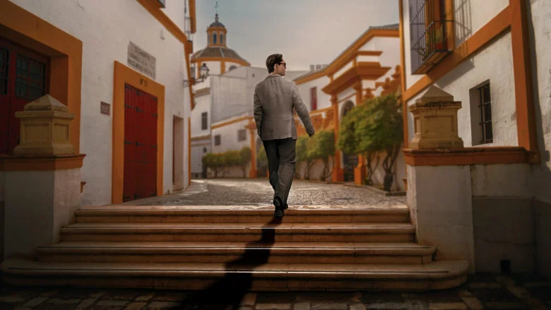 Berlin stands in a Seville plaza at dusk, his silhouette sharp against the warm light, fingers tapping once against his thigh.