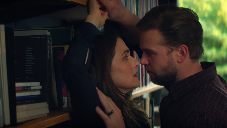 A group of professors at a dinner party, appearing strained and uncomfortable