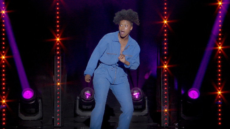Fadily Camara mid-performance, arms outstretched, face alight with exaggerated glee