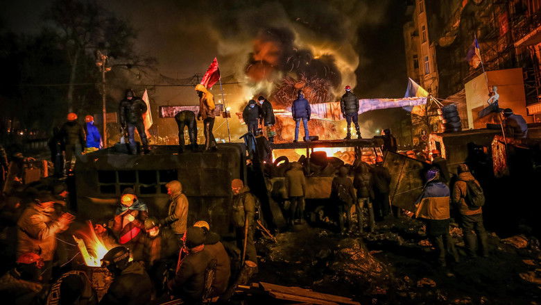 Protesters huddled around a bonfire in Kyiv’s Maidan Square, their faces illuminated by the flames as snow falls.