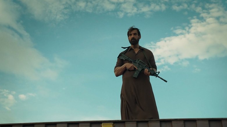 A tense standoff in a dimly lit Tehran alley, with John Abraham’s character poised between shadow and light.