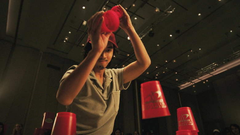 A close-up of Urk’s hands, fingers blurred in motion as he stacks cups in a dizzying pattern