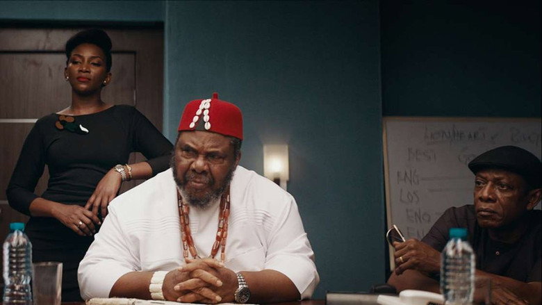 Adaeze stands in the Lionheart Motors office, her expression a mix of frustration and determination as she watches her uncle Godswill take credit for her work.