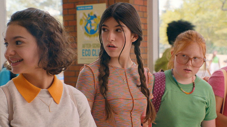 Stacy and Lydia in their bat mitzvah dresses, standing back-to-back in a moment of tension