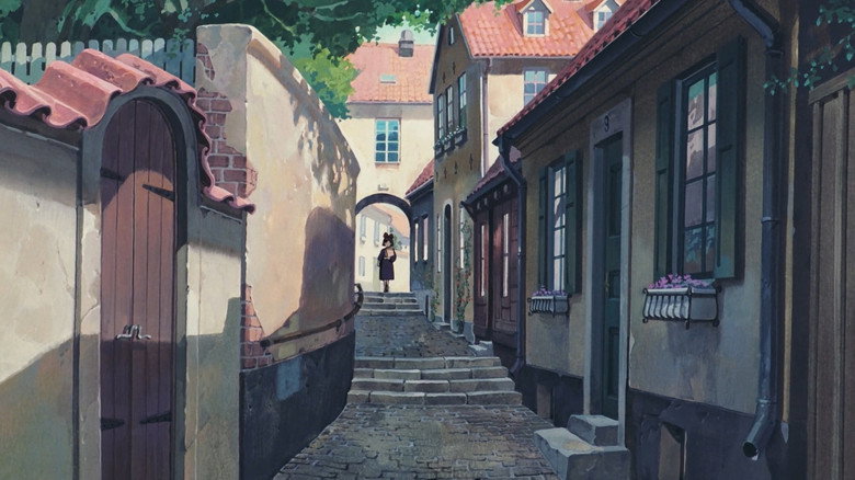 Kiki sits in the cozy, cluttered interior of the bakery, grappling with the weight of her new life.