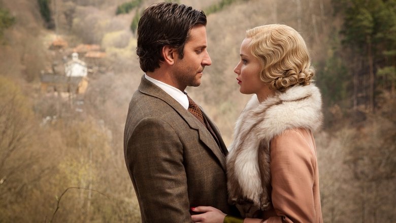 Bradley Cooper and Jennifer Lawrence standing in a misty forest, the rifle resting against Serena's shoulder