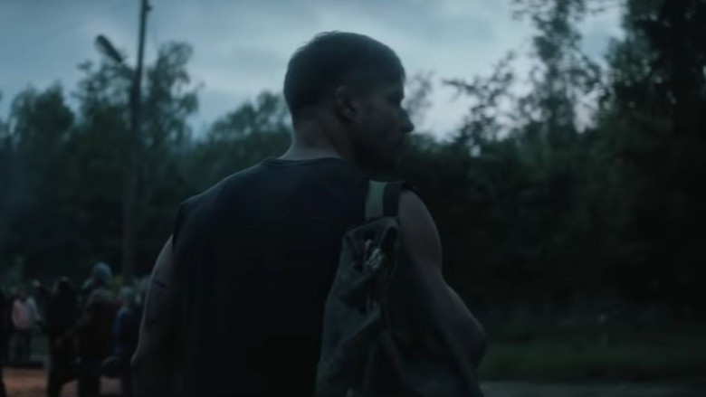 A tense encounter between the protagonist and the antagonist in a darkly lit room