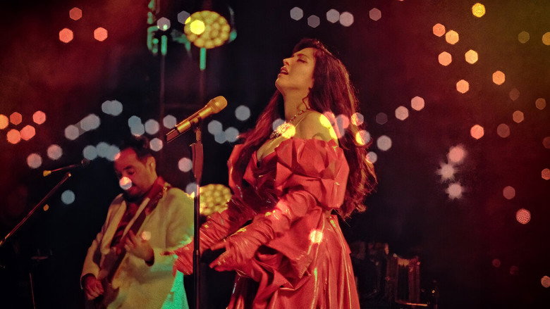 Mon Laferte on stage, bathed in warm light, her face a mix of exhaustion and exhilaration