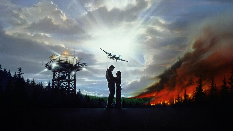 Aerial firefighters battling a wildfire from above, the plane's shadow cutting across the flames