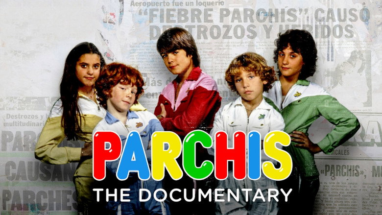A vintage Parchís promotional shot, the five members in bright red tracksuits with white stripes, grinning under a disco ball