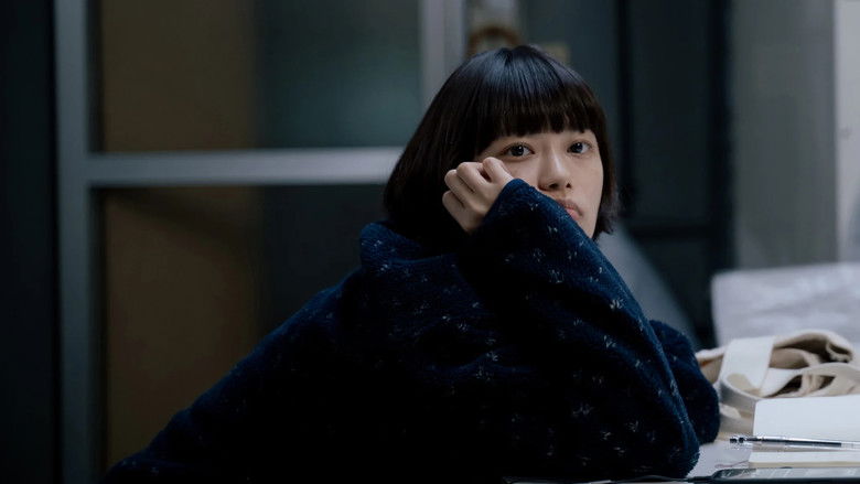 Yukio looking quietly across the washing machines