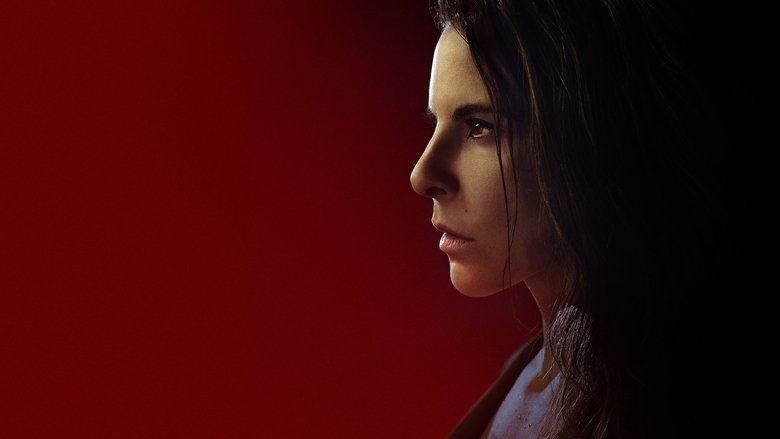 Emilia Urquiza stands in a grand, dimly lit hallway, her expression caught between resolve and exhaustion