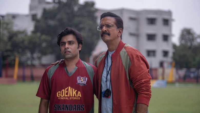 A wide shot of Neemuch’s dusty football field, where Meenu stands in the center, surrounded by a ragtag team of players who look as lost as he feels.