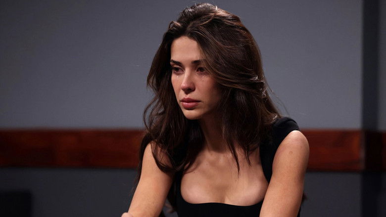 Two men sitting at opposite ends of a long, dimly lit table