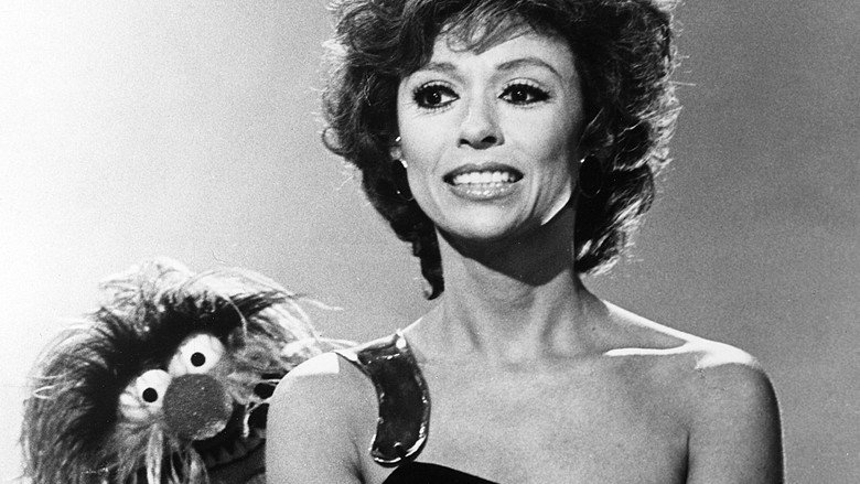 Rita Moreno in a moment of quiet reflection, her expression layered with decades of experience
