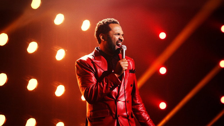 Mike Epps on stage at the Walker Theatre, bathed in warm light, gesturing to the crowd