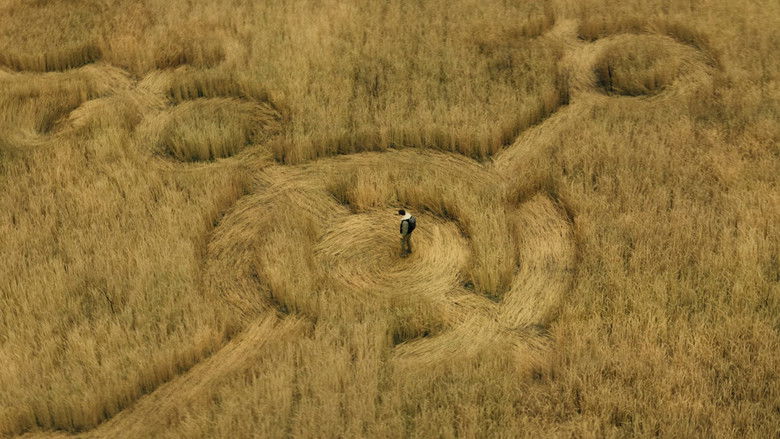 Silhouettes standing before a blinding, blown-out light source