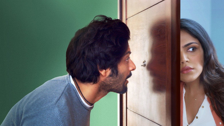 A cluttered Delhi apartment, bathed in warm yellow light, with Karan (Ali Fazal) staring at a mysterious package on his coffee table.