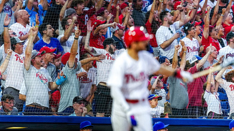 A sea of Phillies fans in red, their faces a mix of hope and exhaustion, filling the stands of Citizens Bank Park.