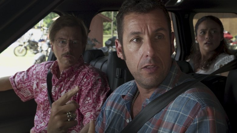 A dimly lit motel room, the kind with peeling wallpaper and a flickering neon sign outside the window. Sandler and Spade sit on opposite beds, staring at a map spread between them, their faces half-lit by the glow of a single lamp.