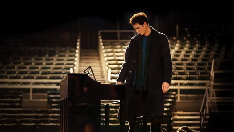 Andrew Garfield as Jonathan Larson, mid-song, his face lit with the intensity of performance