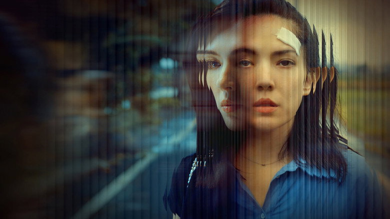 A hospital room bathed in cold blue light, the protagonist's face half in shadow as she stares at her own reflection in a window.