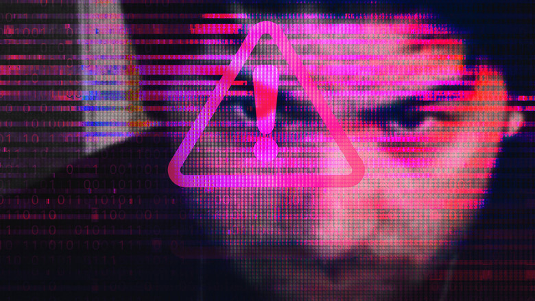 A dimly lit computer screen glows with the ominous interface of Hunter Moore’s revenge porn site, its pixelated text a stark contrast to the darkness around it.