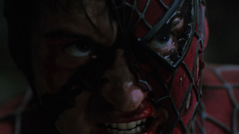 Peter Parker clinging to a wall in the rain