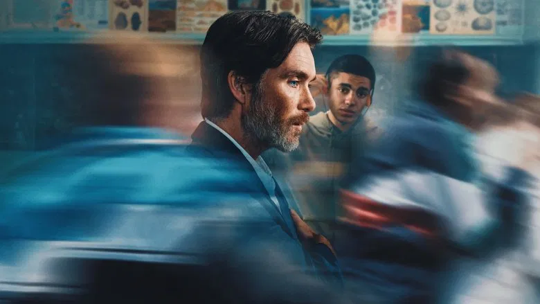 A dimly lit hallway in the reform school, where Steve stands with his back to the camera, his posture slumped under the weight of the institution.