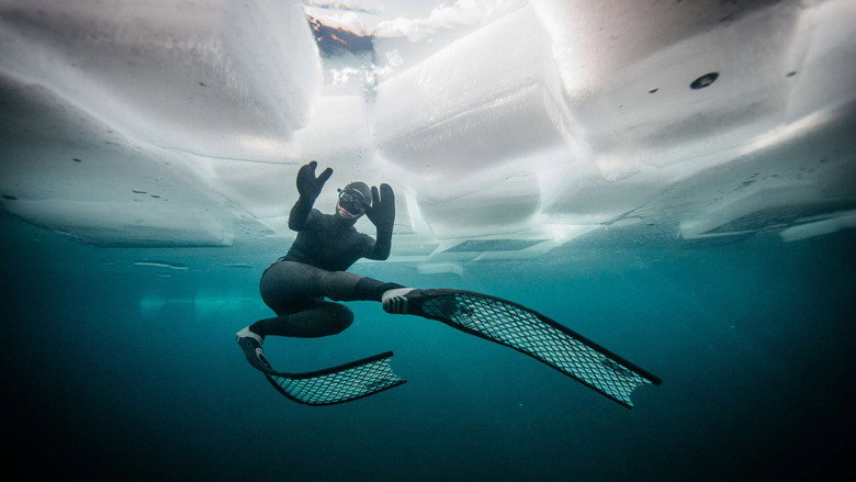 Johanna Nordblad emerges from a hole in the ice, her face a mask of concentration and cold