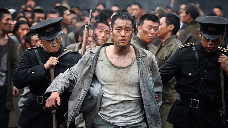 A group of Korean laborers huddle in the dim light of a coal mine, their faces streaked with soot and exhaustion.