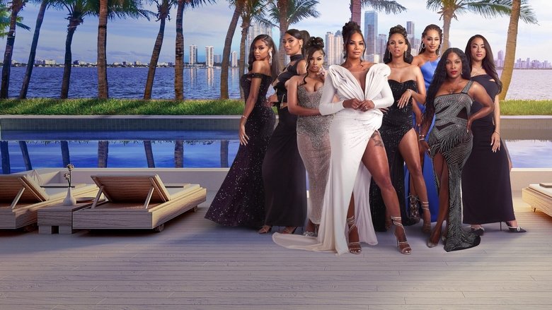 A group of women in sleek, form-fitting dresses stand in a sunlit room with floor-to-ceiling windows, their expressions a mix of confidence and tension.