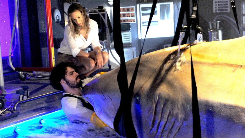 A wide shot showing the scale of the underwater complex surrounded by dark water