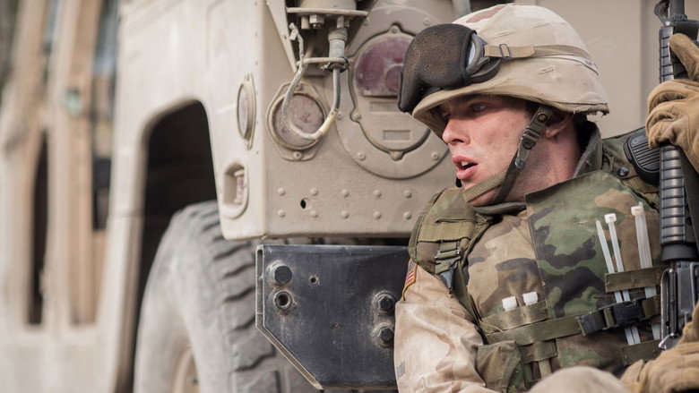 A group of soldiers and villagers stand in a dusty Iraqi village, the weight of unspoken tension hanging in the air.