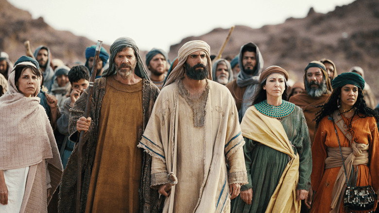 Moses standing before the burning bush, the flames flickering in the desert night